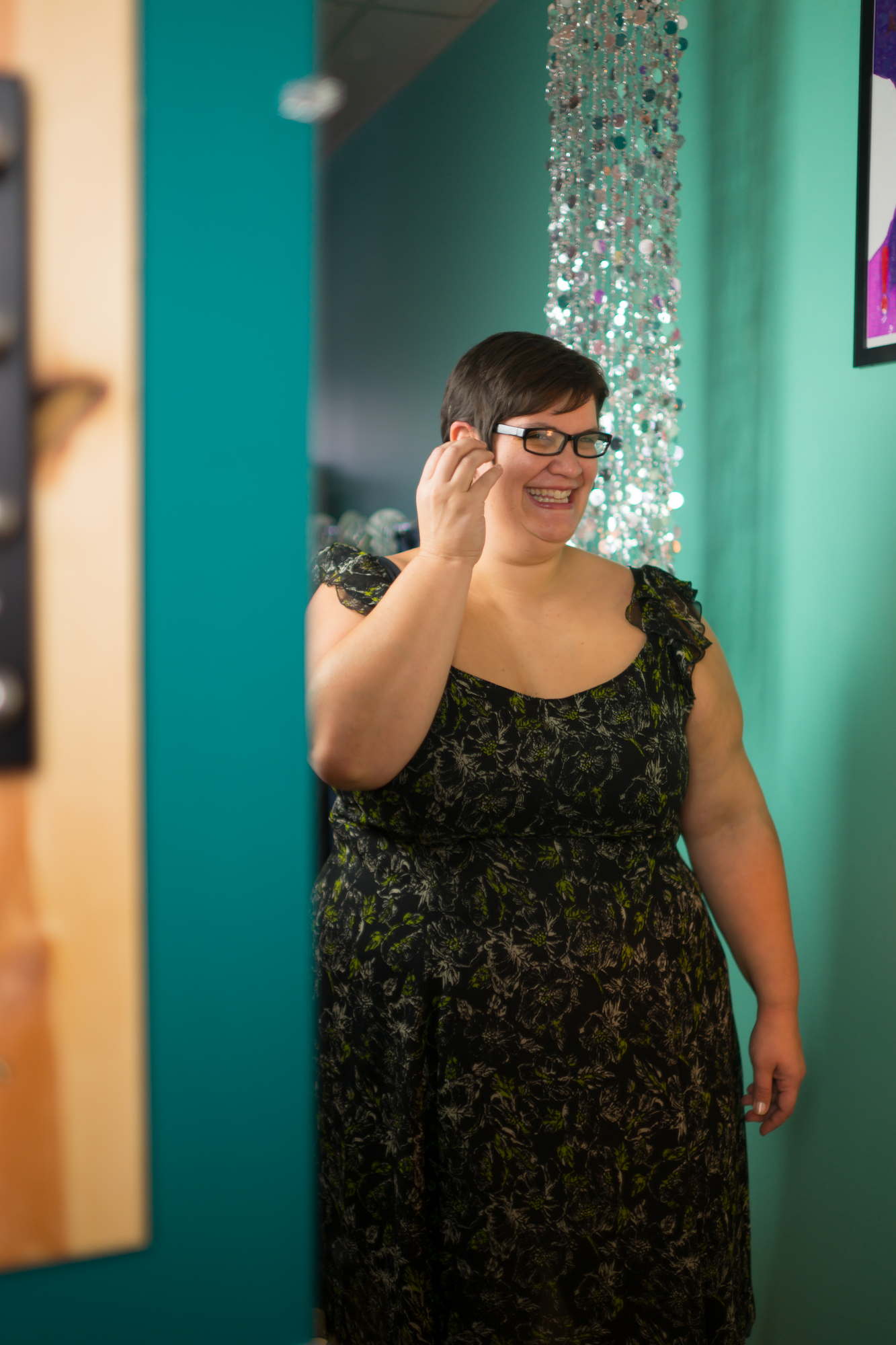 A fat woman laughs in a dark dress during a potrait photo shoot