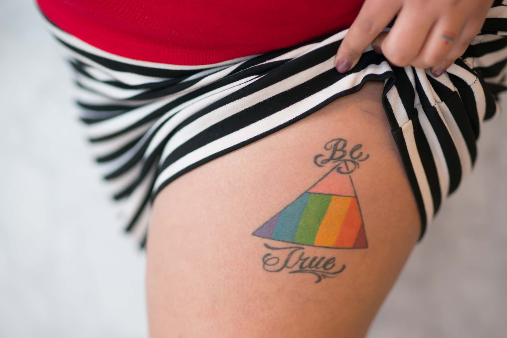A fat woman's leg with a pride tattoo for an lgbt friendly photo shoot