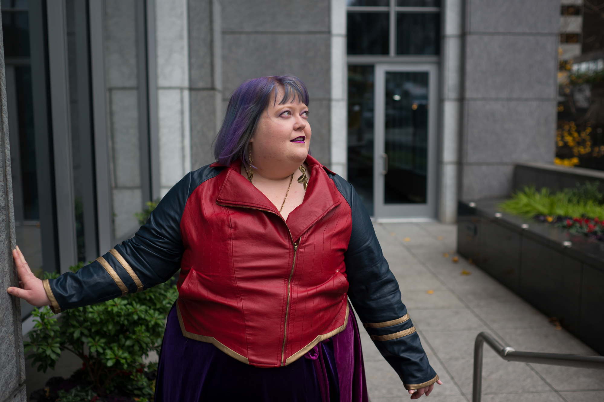 A fat woman with purple hair gazes wistfully off to the side