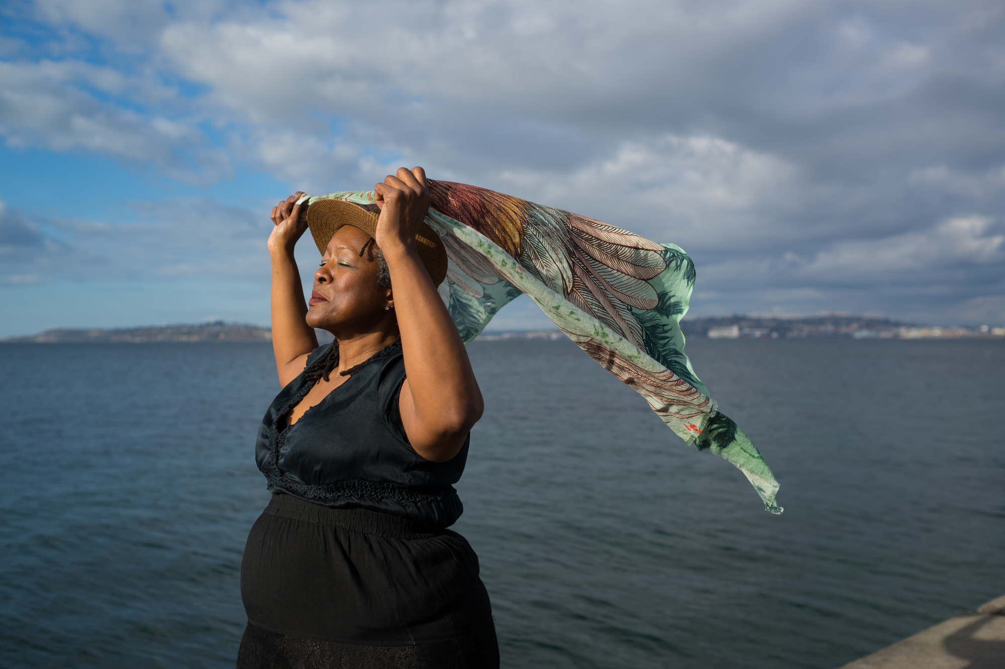 A fat Black woman poses confidently in front of a lake in Washington