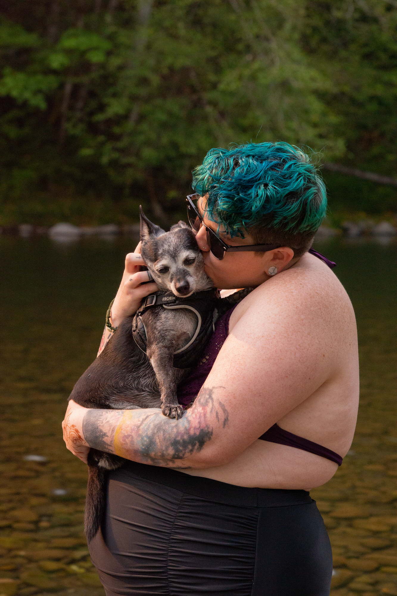 A fat woman kisses a dog in a river in Washington