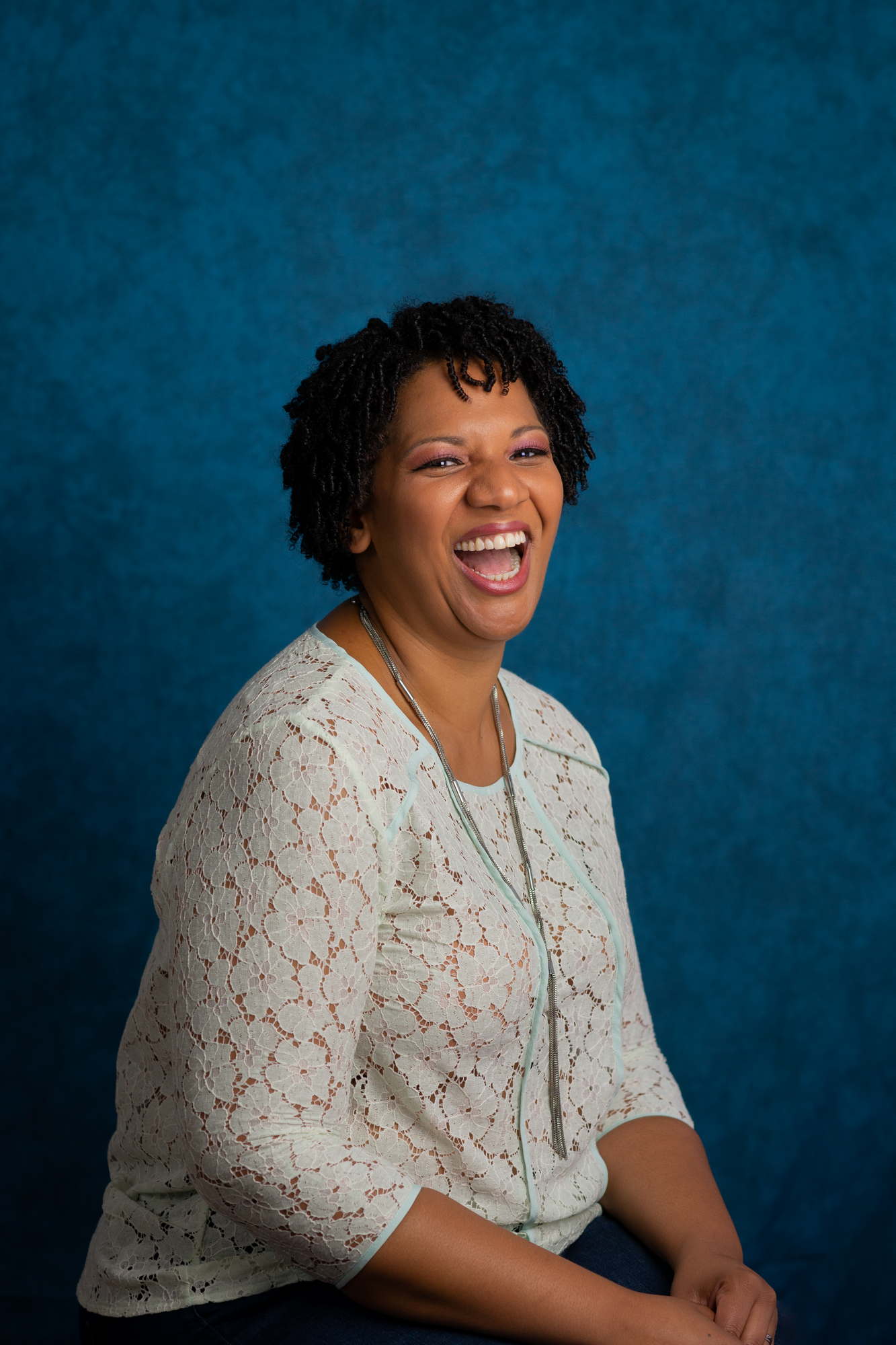 A Black woman laughs confidently during a business headshot session in the PNW