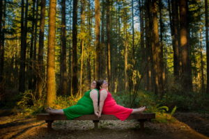 Two fat women pose together on a bench in the woods during an LGBT+ friendly photo shoot in WA