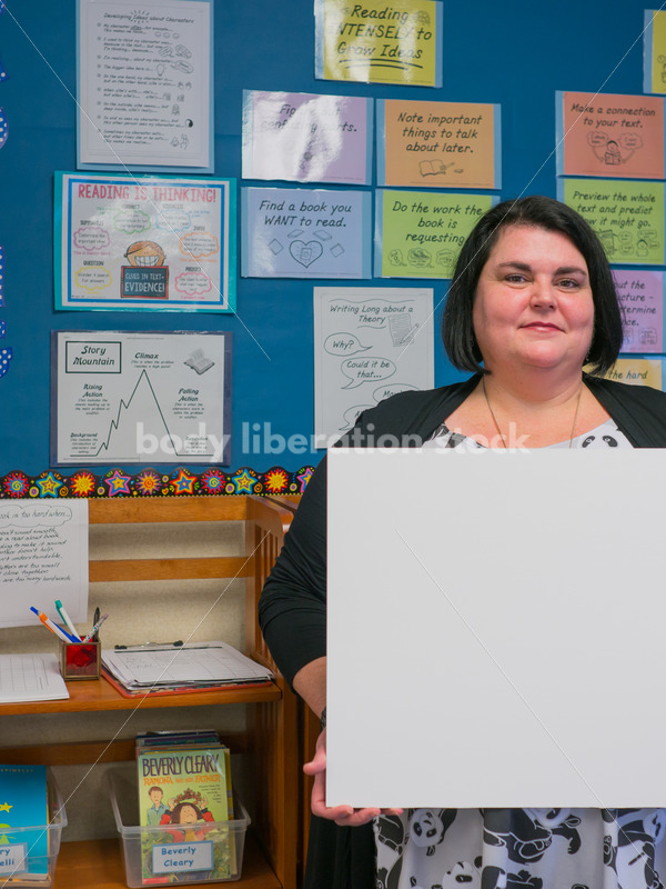 Body Positive Stock Image: Plus Size Teacher with Blank Sign for Your Text - Body Liberation Photos
