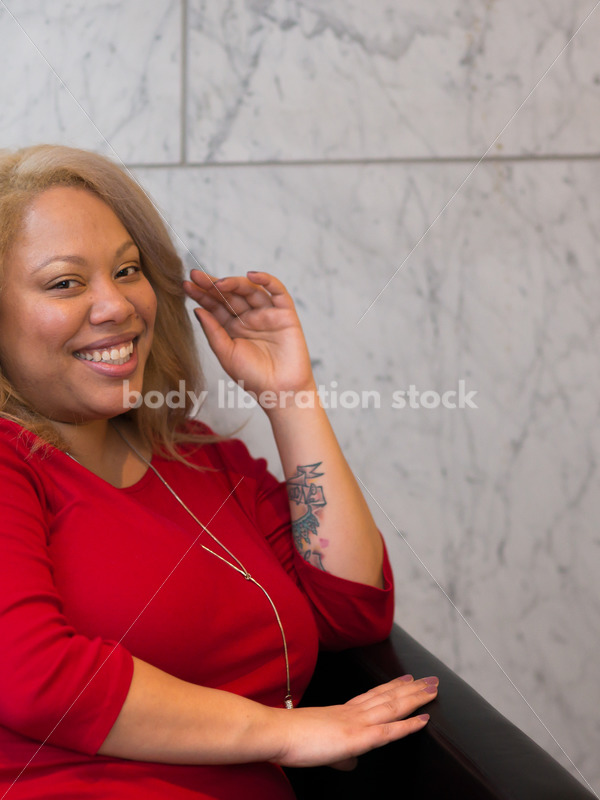 Business Stock Image: Plus Size Black Woman Sitting in Office Building Lobby - Body Liberation Photos