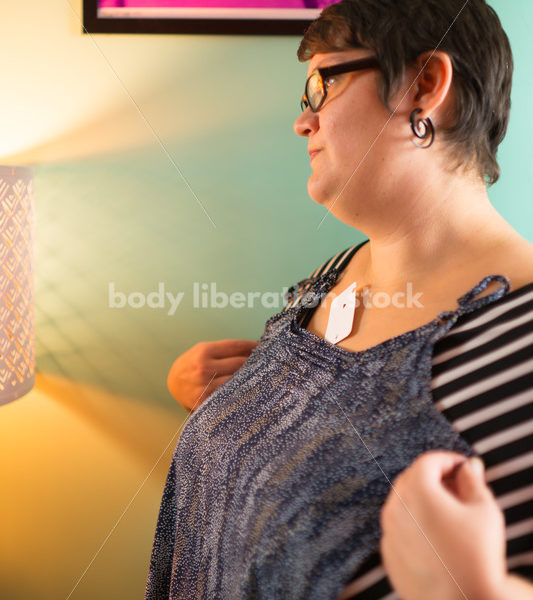 Clothing Retail Stock Photo: Plus Size Woman Tries on Clothes in Dressing Room - Body Liberation Photos