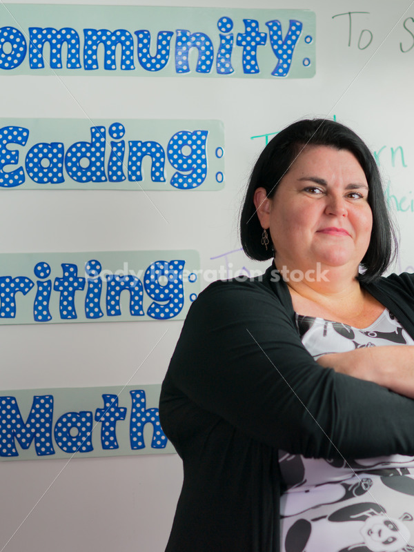 Education Stock Photo: Plus Size Elementary School Teacher with Crossed Arms - Body Liberation Photos