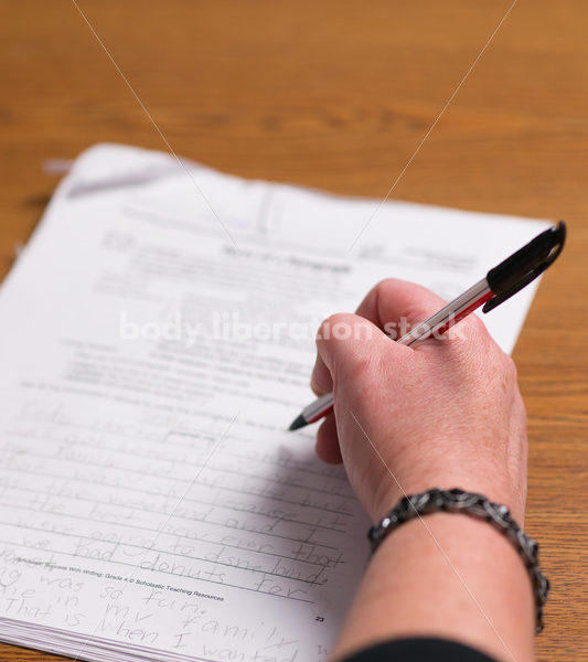 Education Stock Photo: Plus Size Teacher Grading Papers - Body Liberation Photos