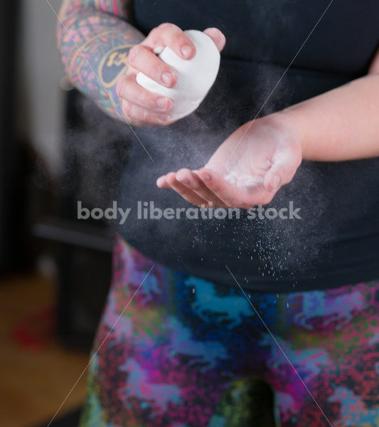 HAES Stock Photo: Female Weightlifter Uses Chalk Ball in Gym - Body Liberation Photos