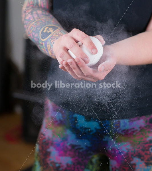 HAES Stock Photo: Female Weightlifter Uses Chalk Ball in Gym - Body Liberation Photos