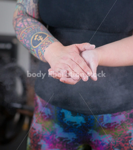 HAES Stock Photo: Female Weightlifter Uses Chalk Ball in Gym - Body Liberation Photos