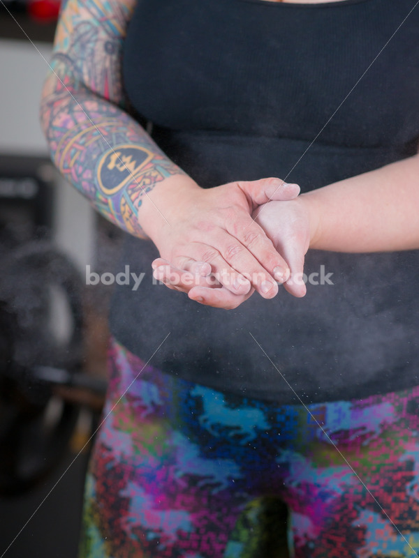 HAES Stock Photo: Female Weightlifter Uses Chalk Ball in Gym - Body Liberation Photos