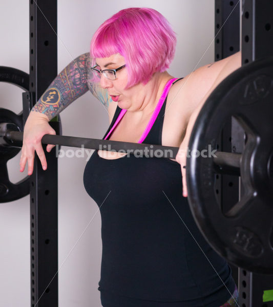 HAES Stock Photo: Female Weightlifter with Pink Hair Does Squat in Gym - Body Liberation Photos