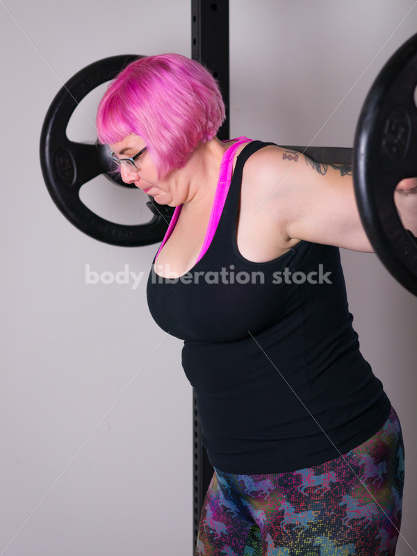 HAES Stock Photo: Female Weightlifter with Pink Hair Does Squat in Gym - Body Liberation Photos
