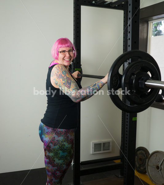 HAES Stock Photo: Female Weightlifter with Pink Hair Does Wide Stance Squat - Body Liberation Photos