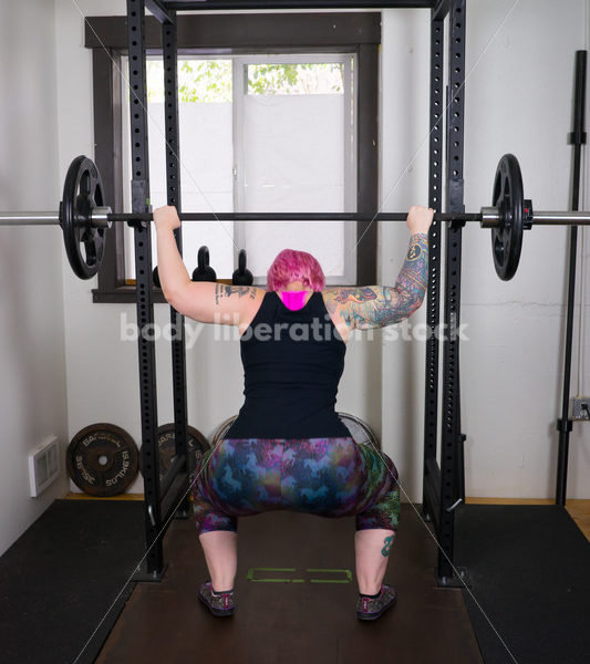 HAES Stock Photo: Female Weightlifter with Pink Hair Does Wide Stance Squat - Body Liberation Photos