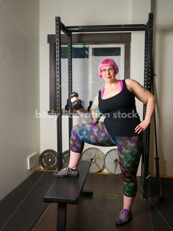 HAES Stock Photo: Female Weightlifter with Pink Hair Lifts Hand Weights in Gym - Body Liberation Photos