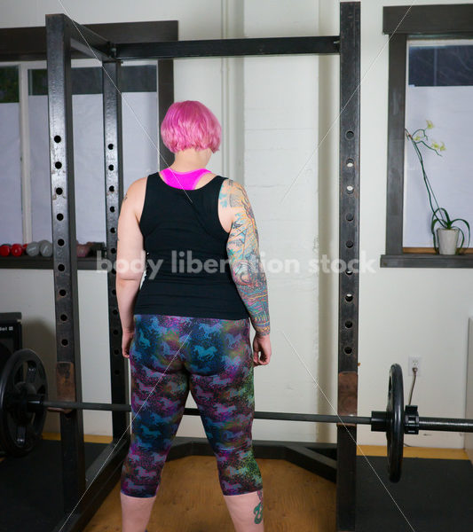 HAES Stock Photo: Female Weightlifter with Pink Hair Lifts Heavy Weight in Gym - Body Liberation Photos