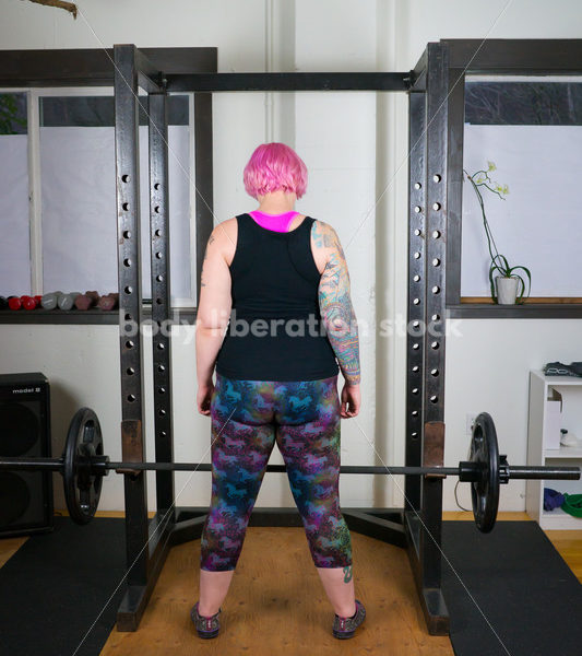 HAES Stock Photo: Female Weightlifter with Pink Hair Lifts Heavy Weight in Gym - Body Liberation Photos