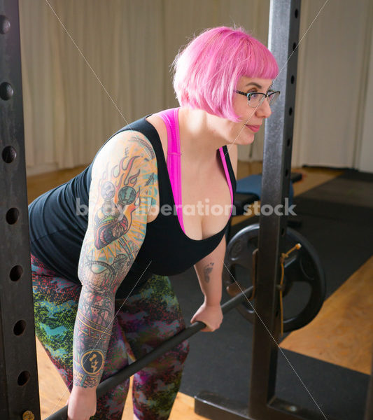 HAES Stock Photo: Female Weightlifter with Pink Hair Lifts Heavy Weight in Gym - Body Liberation Photos