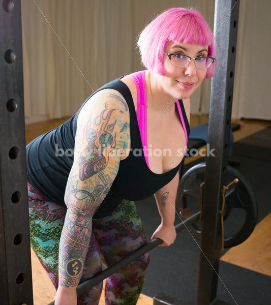 HAES Stock Photo: Female Weightlifter with Pink Hair Lifts Heavy Weight in Gym - Body Liberation Photos