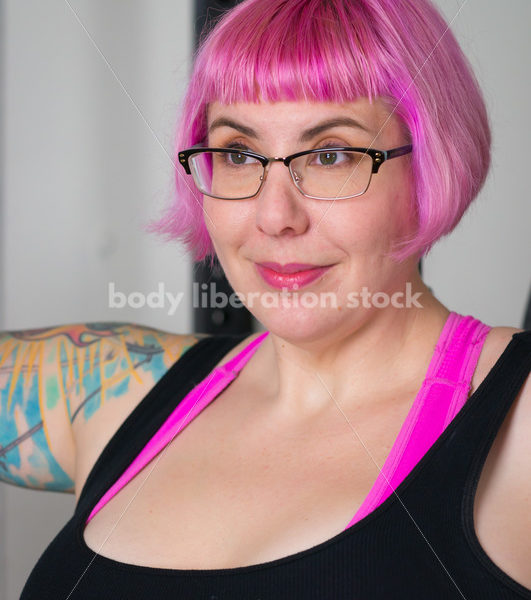 HAES Stock Photo: Female Weightlifter with Pink Hair Standing in Weight Lifting Gym - Body Liberation Photos