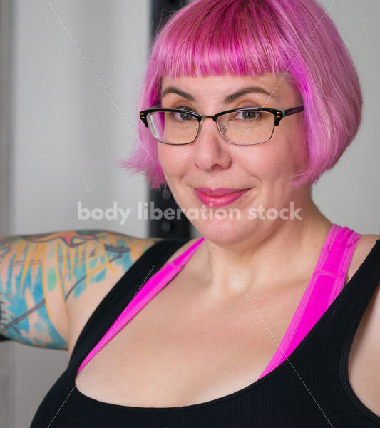 HAES Stock Photo: Female Weightlifter with Pink Hair Standing in Weight Lifting Gym - Body Liberation Photos