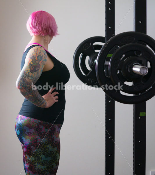 HAES Stock Photo: Female Weightlifter with Pink Hair Standing in Weight Lifting Gym - Body Liberation Photos