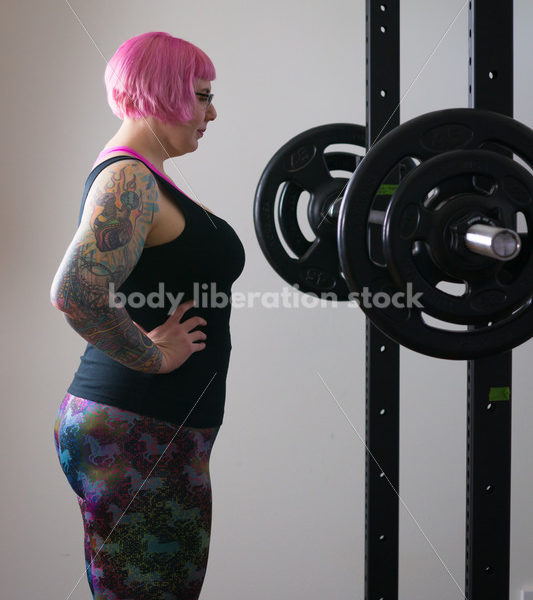 HAES Stock Photo: Female Weightlifter with Pink Hair Standing in Weight Lifting Gym - Body Liberation Photos