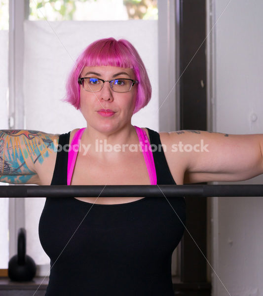 HAES Stock Photo: Female Weightlifter with Pink Hair Standing in Weight Lifting Gym - Body Liberation Photos