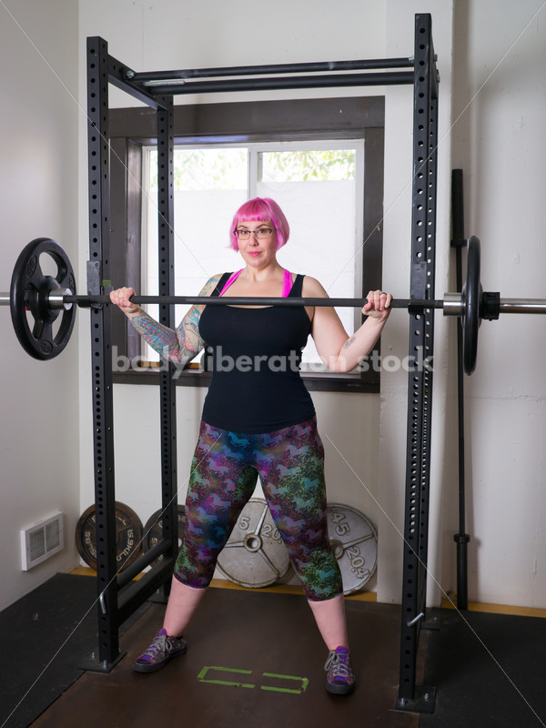 HAES Stock Photo: Female Weightlifter with Pink Hair Standing in Weight Lifting Gym - Body Liberation Photos
