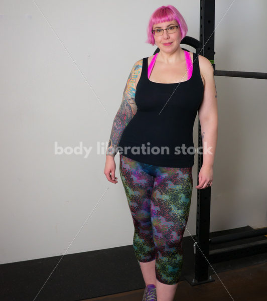 HAES Stock Photo: Female Weightlifter with Pink Hair Stands in Weight Lifting Gym - Body Liberation Photos