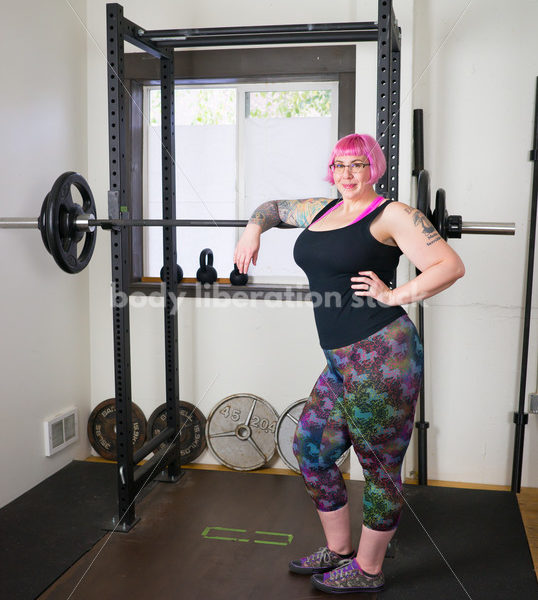 HAES Stock Photo: Female Weightlifter with Pink Hair Stands in Weight Lifting Gym - Body Liberation Photos