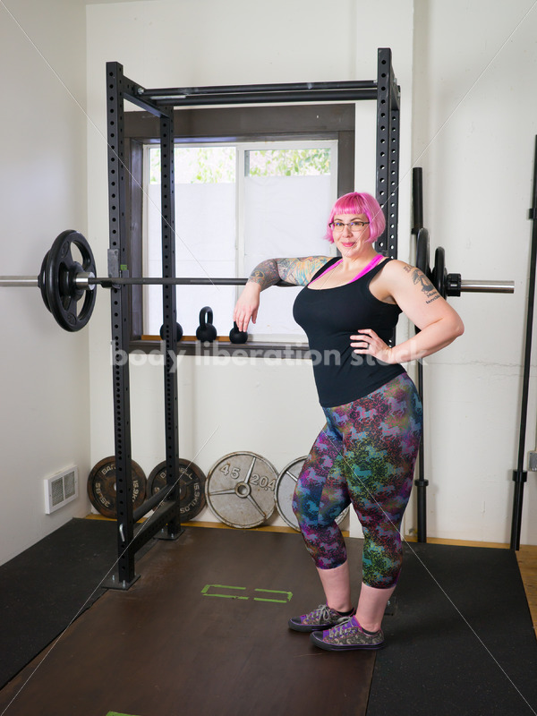 HAES Stock Photo: Female Weightlifter with Pink Hair Stands in Weight Lifting Gym - Body Liberation Photos