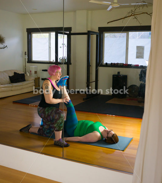 HAES Stock Photo: Personal Trainer Helps Client in Stretching Exercise - Body Liberation Photos