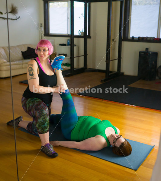 HAES Stock Photo: Personal Trainer Helps Client in Stretching Exercise - Body Liberation Photos