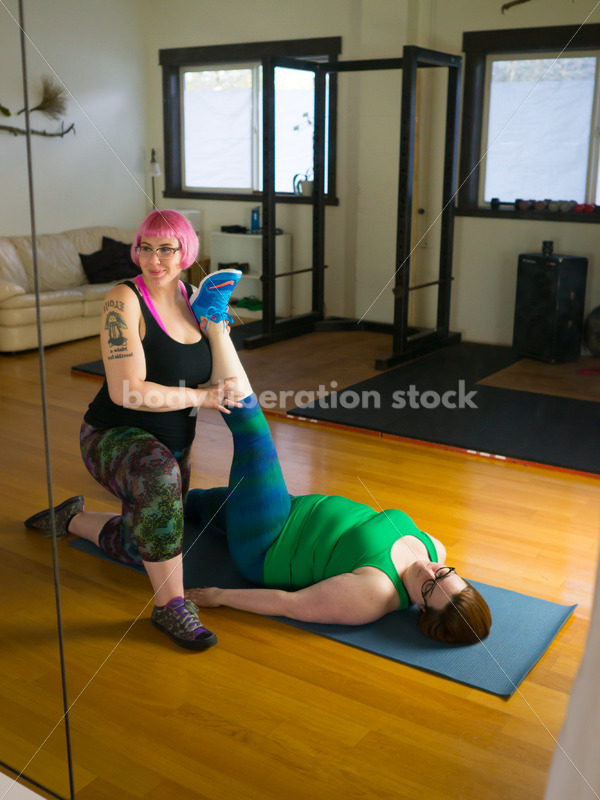 HAES Stock Photo: Personal Trainer Helps Client in Stretching Exercise - Body Liberation Photos