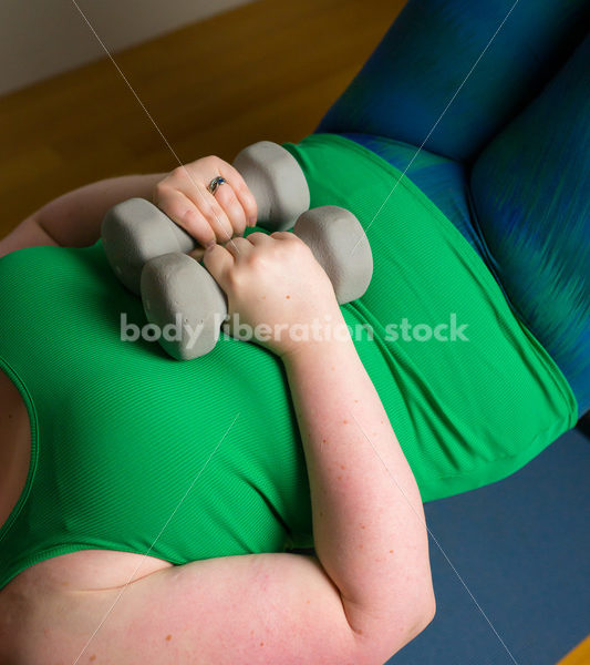 HAES Stock Photo: Personal Trainer Helps Client with Form in Lifting Hand Weights - Body Liberation Photos