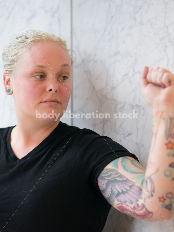 Human Rights & LGBT Stock Photo: Lesbian Woman Raising Fist for Protest - Body Liberation Photos