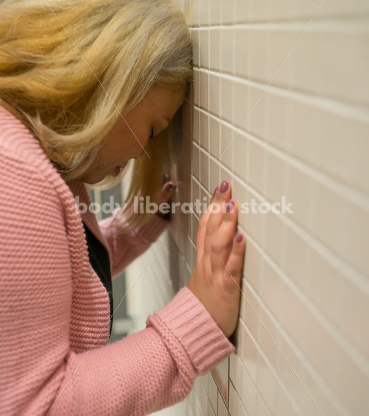 Mental Health and Illness Stock Image: Depressed Plus Size Woman in Office Building Bathroom - Body Liberation Photos