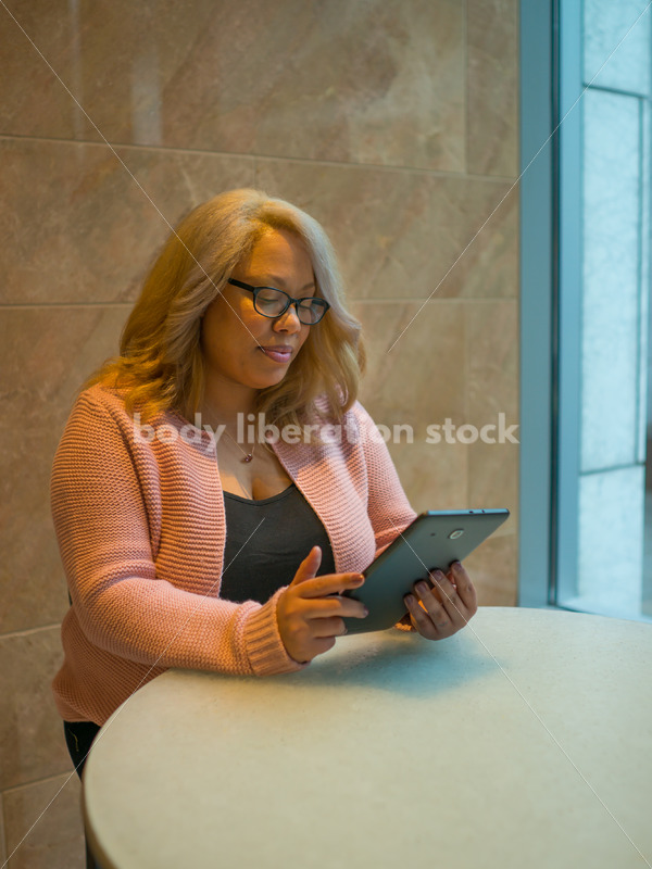 Royalty-Free Business Image: Black LGBT Woman Using Tablet Computer - Body Liberation Photos