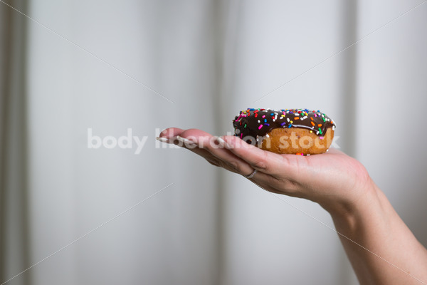 Royalty Free Stock Photo: Black Woman with Chocolate Glazed Donut - Body Liberation Photos