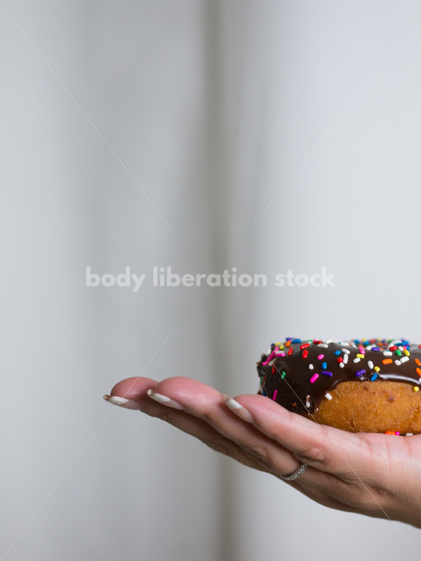 Royalty Free Stock Photo: Black Woman with Chocolate Glazed Donut - Body Liberation Photos