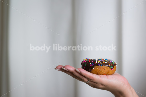 Royalty Free Stock Photo: Black Woman with Chocolate Glazed Donut - Body Liberation Photos