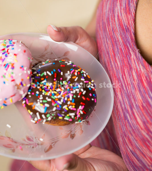 Royalty Free Stock Photo: Black Woman with Glazed Donuts - Body Liberation Photos