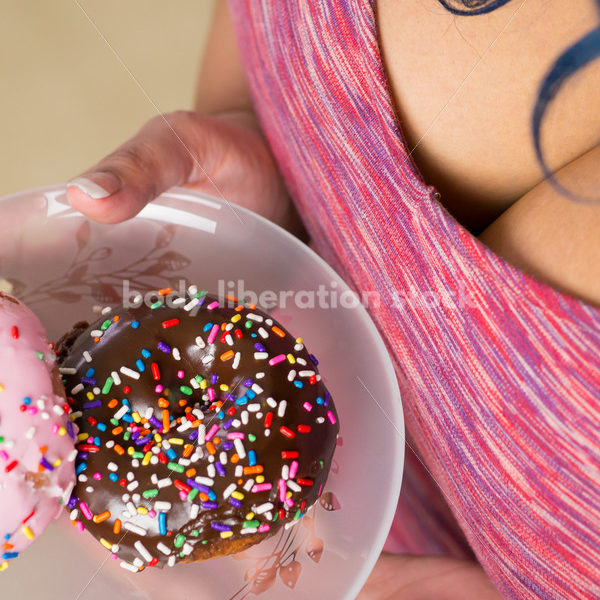 Royalty Free Stock Photo: Black Woman with Glazed Donuts - Body Liberation Photos