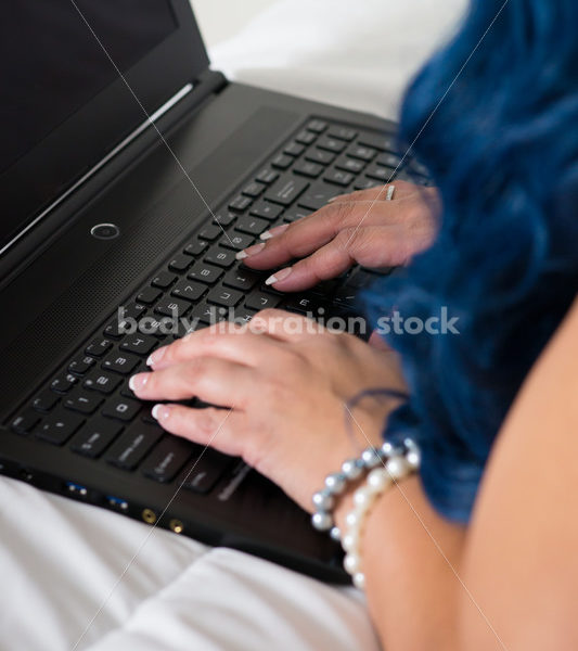 Royalty Free Stock Photo: Plus Size African American Woman Uses Laptop Computer on Bed - Body Liberation Photos