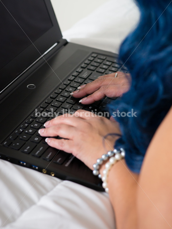 Royalty Free Stock Photo: Plus Size African American Woman Uses Laptop Computer on Bed - Body Liberation Photos