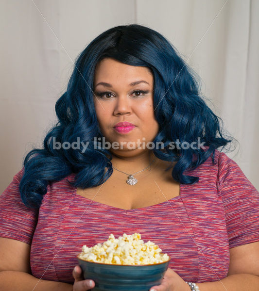 Royalty Free Stock Photo: Plus Size Black Woman with Bowl of Popcorn - Body Liberation Photos