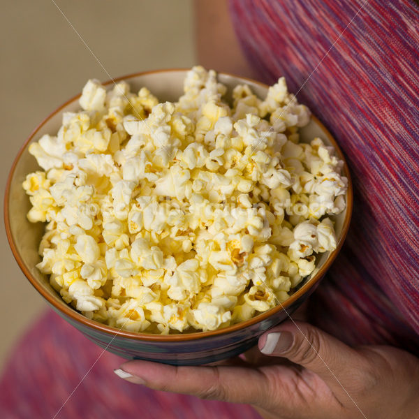 Royalty Free Stock Photo: Plus Size Black Woman with Bowl of Popcorn - Body Liberation Photos